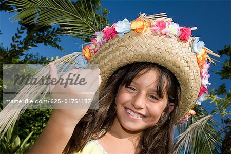 Portrait of a girl wearing a straw hat and smiling