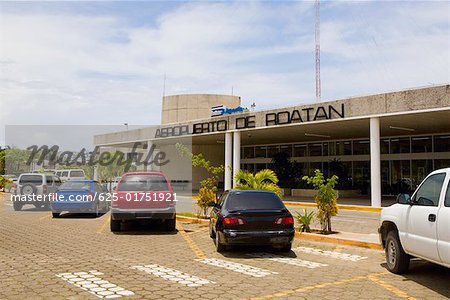 Cars parked in front of an airport entrance, Roatan, Bay Islands, Honduras