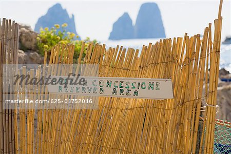 Close-up of an information board on a wooden fence, Capri, Campania, Italy