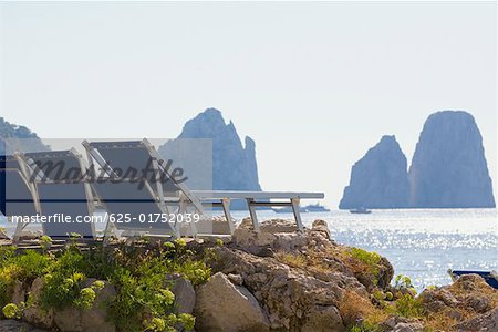 Deck chairs on a rock, Faraglioni Rocks, Capri, Campania, Italy