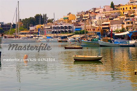 Boats in water with buildings in the background, Athens, Greece