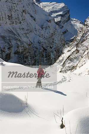 Male hiker walking in a snow covered landscape, Annapurna Range, Himalayas, Nepal