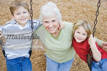 Woman with Grandsons on Swings