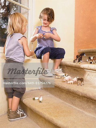 Little girls with plastic animals.