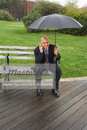 Businessman on Park Bench in Rain, New York City, New York, USA