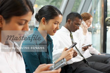 Business People in Foyer with Electronic Organizers, Toronto, Ontario, Canada