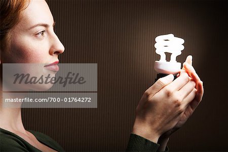 Woman Holding Energy Efficient Light Bulb