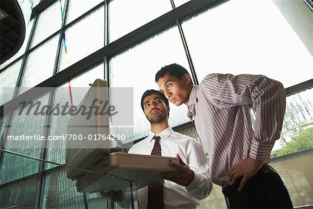 Businessmen Looking Inside Glowing Briefcase