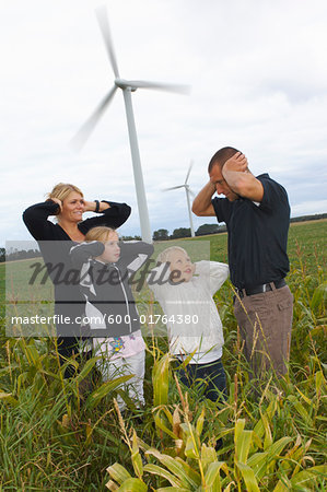Family Covering Ears near Wind Turbines, Denmark