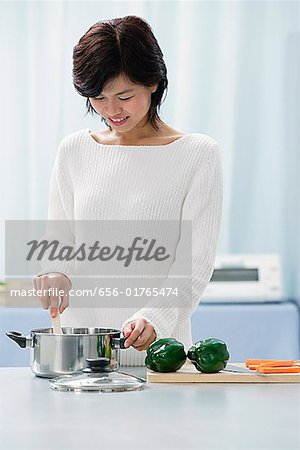 Woman in kitchen, cooking