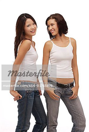 Two young women standing together smiling