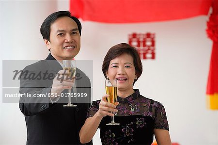 A couple raise their glasses for a toast