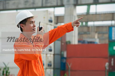 Construction worker giving directions on walkie talkie