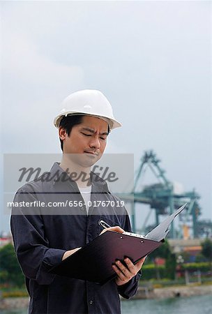 Mann mit harten Helm in Zwischenablage schreiben