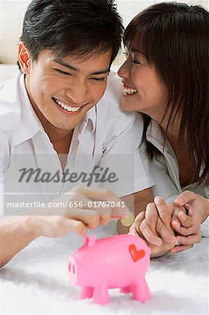 Young couple with piggy bank
