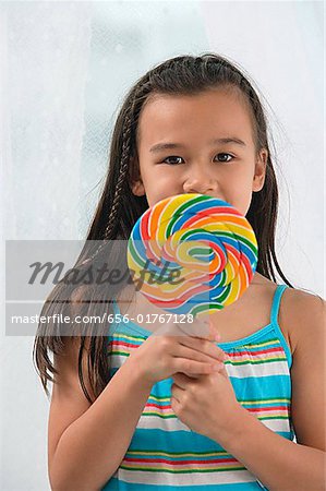 Young girl with big lollipop