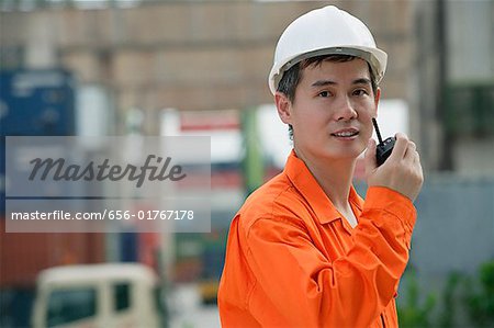 Construction worker talking on walkie talkie