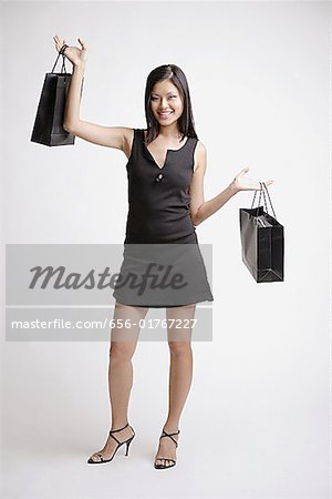 Young woman with shopping bags, smiling