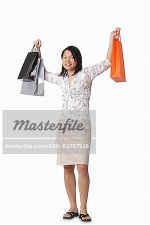 Jeune femme transportant sacs à provisions, portrait