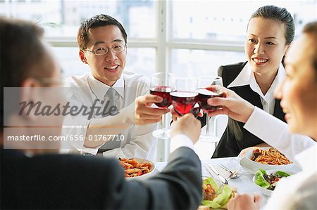 Executives toasting with wine glasses