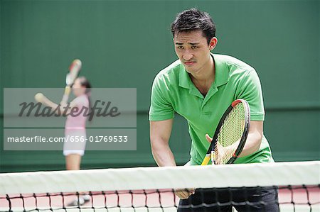 Couple playing tennis