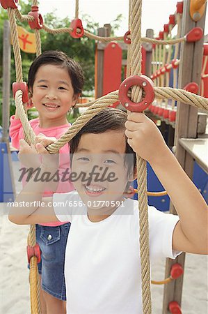 Two girls in playground, looking at camera