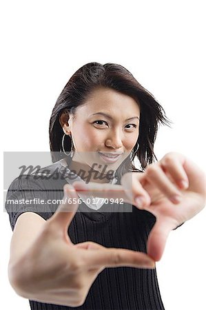 Young woman making hand sign