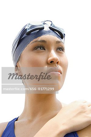 Young woman in swimming cap, head shot
