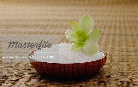 Bowl of rice with a flower, on a tatami mat