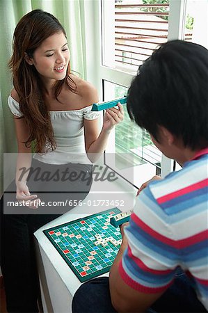 Couple at home playing scrabble