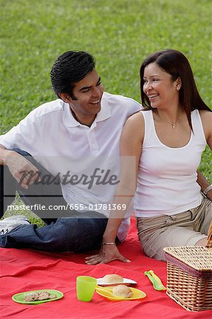 A couple have a picnic together in the park