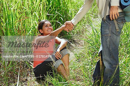 Man helping woman stand up