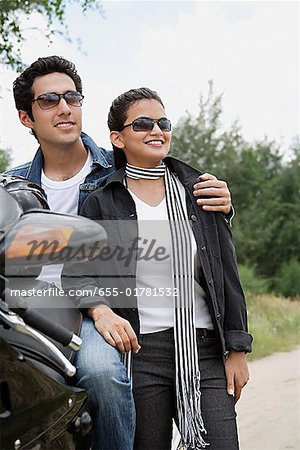 Young couple with motorbike