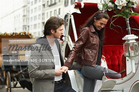 Couple Entering Horse-Drawn Carriage, New York City, New York, USA