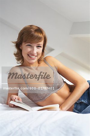 Woman Reading on Bed