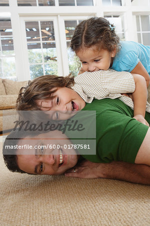 Father and Kids Play Fighting