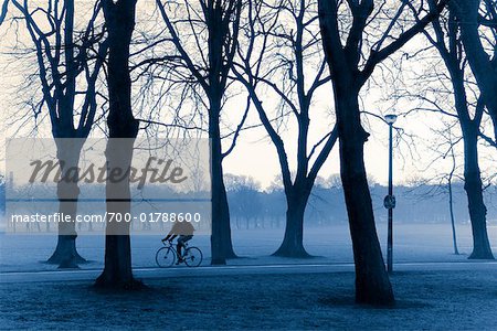 Cyclist Riding through Park, Edinburgh, Scotland