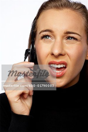 Angry Businesswoman Talking on Headset