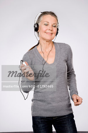 Woman Dancing While Listening to Portable Audio Player