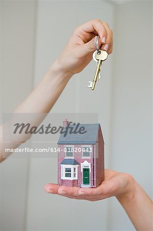 People holding keys and house