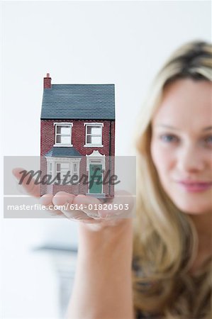 Woman holding a house