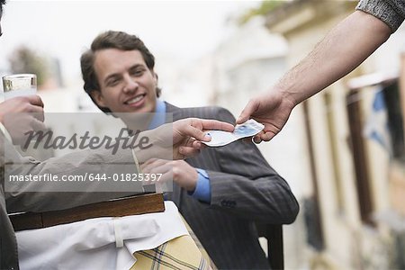 Businessmen at taverna paying bill