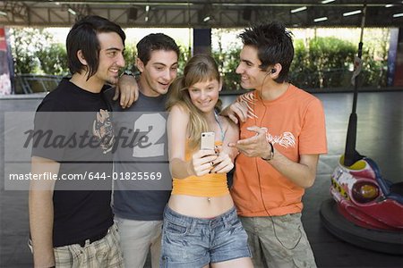 Teenagers photographing themselves in amusement park