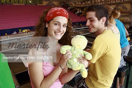 Teenage couple at game in amusement park