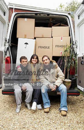 Family Sitting on Back of Moving Van