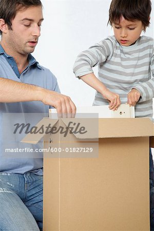 Father and Son Looking through Box