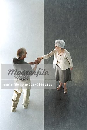 Man shaking woman's hand, high angle view