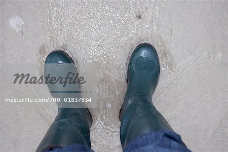 Person Wearing Boots in Water