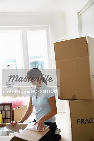 Woman with Boxes in Home