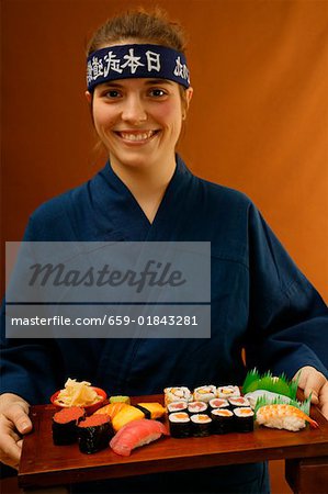 Woman serving sushi platter